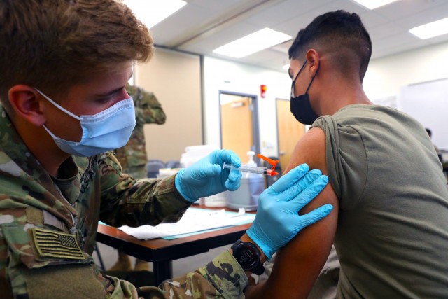 Spc. Tyler Boyer, a Hayden, Colorado native and medical specialist assigned to the 1st Stryker Brigade Combat Team, 4th  Infantry Division, administers the COVID-19 vaccine at Fort Carson, Colorado Aug 3, 2021. The 4th Inf. Div. remains committed...